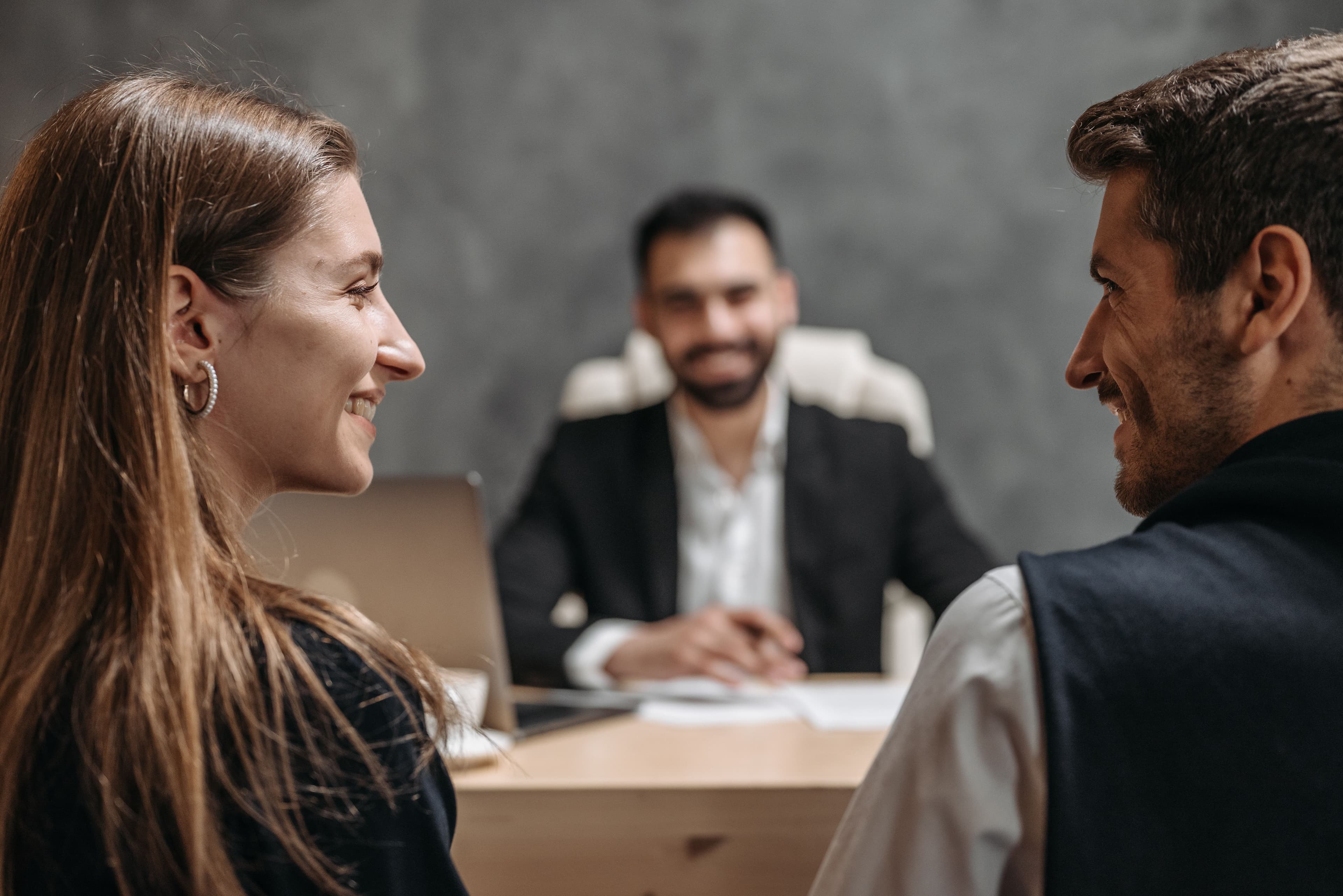 A couple meeting with an insurance advisor across a desk