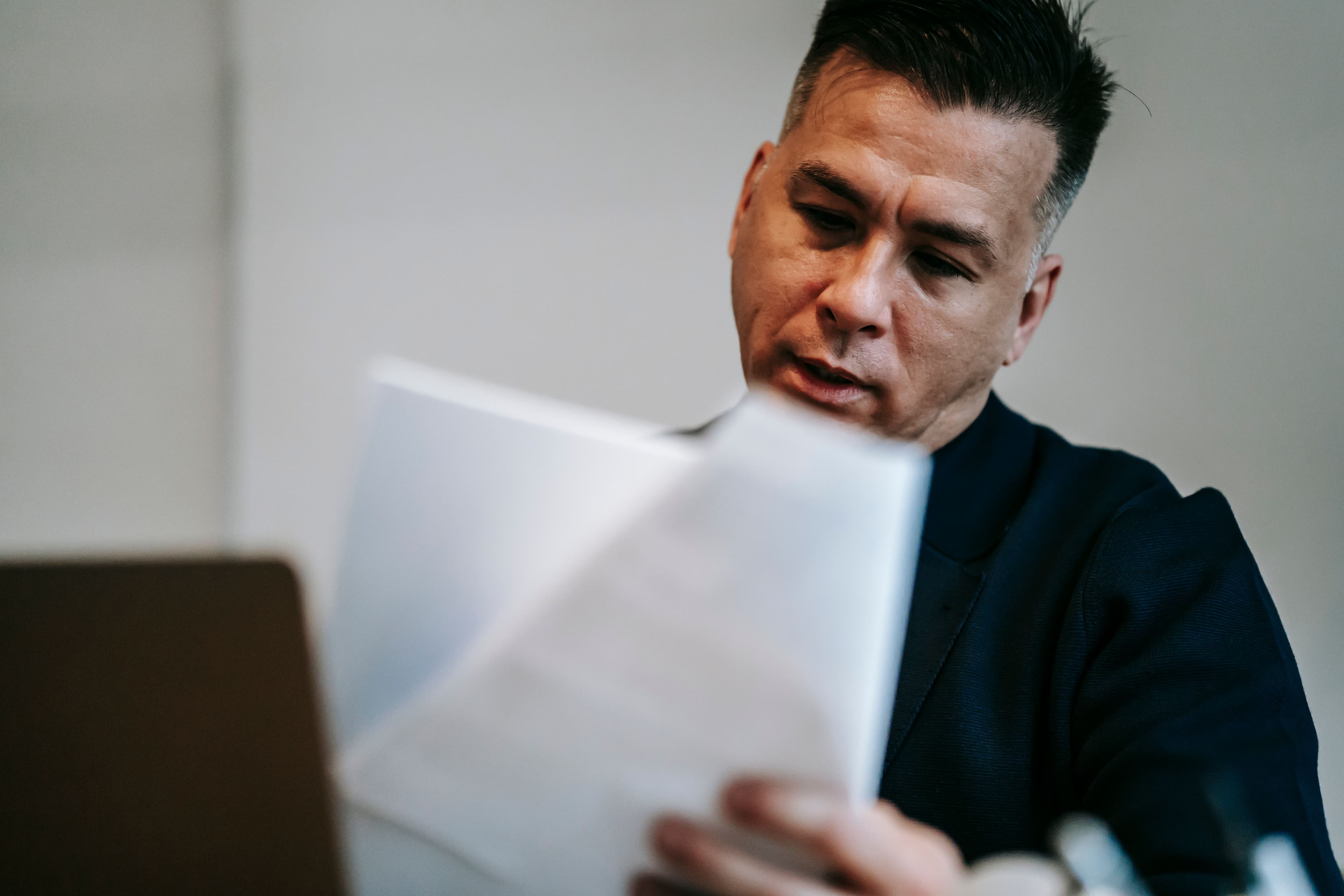 A person reviewing paperwork with a focused expression
